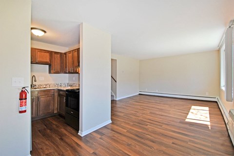 a renovated living room and kitchen with wood flooring