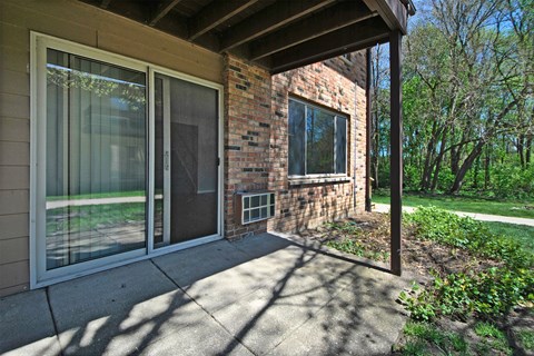 the front porch of a brick house with sliding glass doors