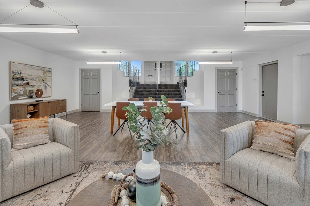 a living room and dining room with couches and a table