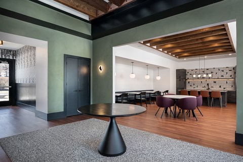A modern dining room with a round table and chairs.