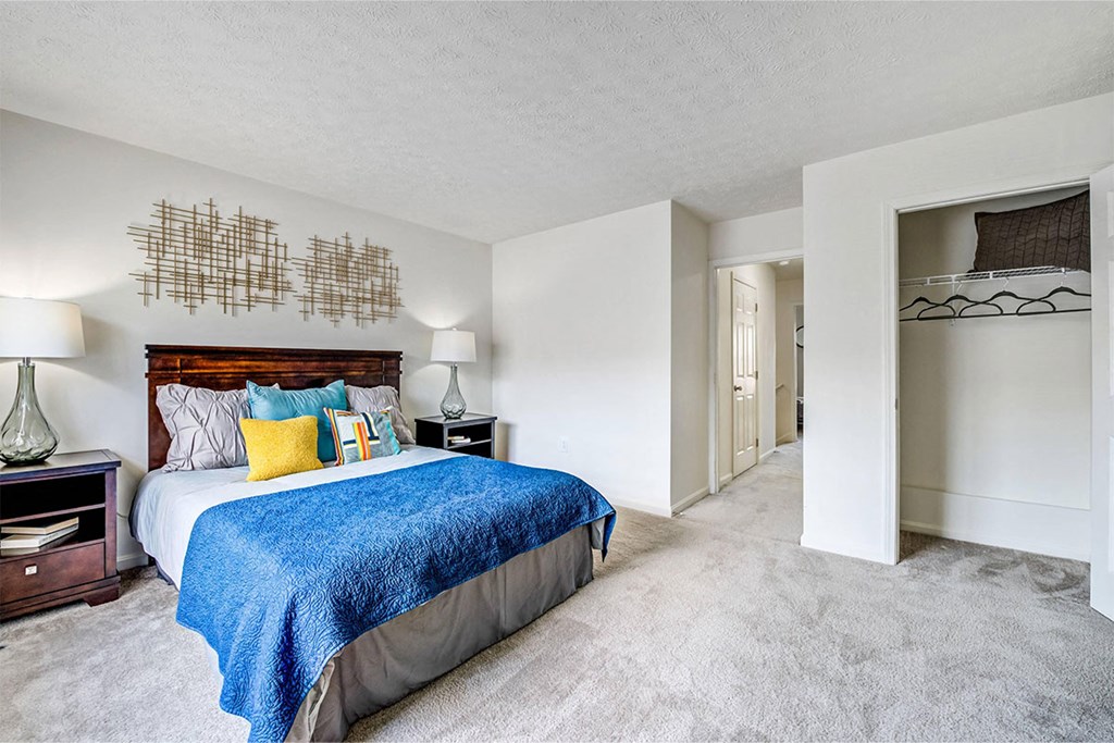 a bedroom with a bed and a closet