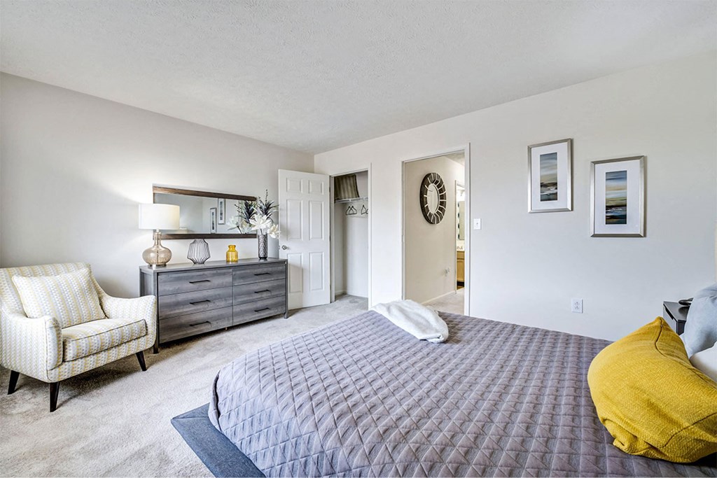 a bedroom with a bed and a dresser