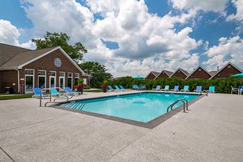 a swimming pool in front of a resort style building
