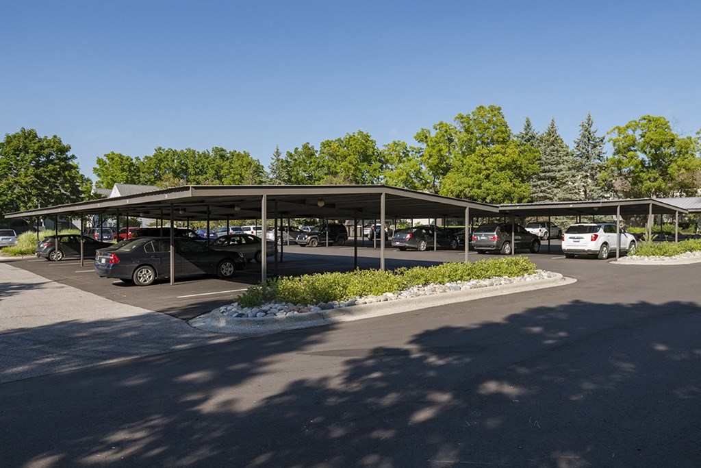 a parking lot with cars parked under a roof