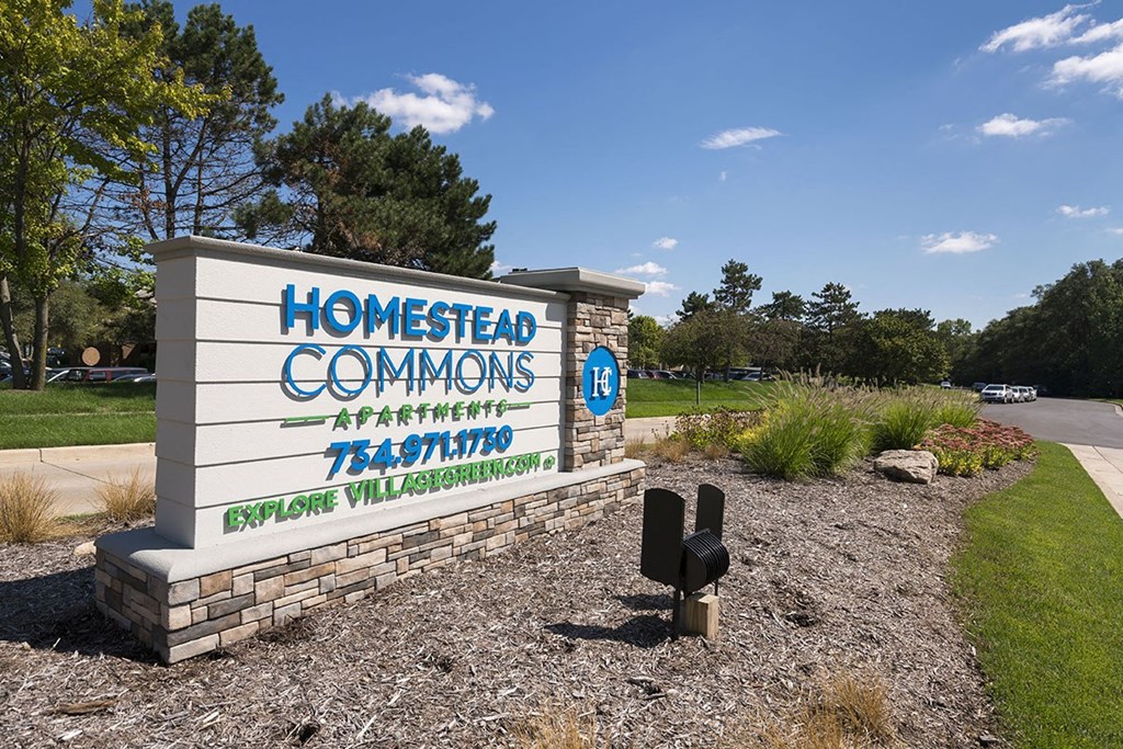 a sign for homestead common on the side of a road