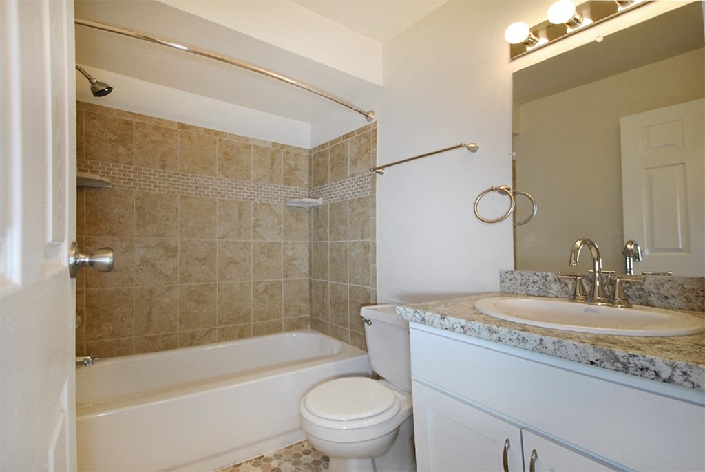 a bathroom with a sink toilet and a bath tub