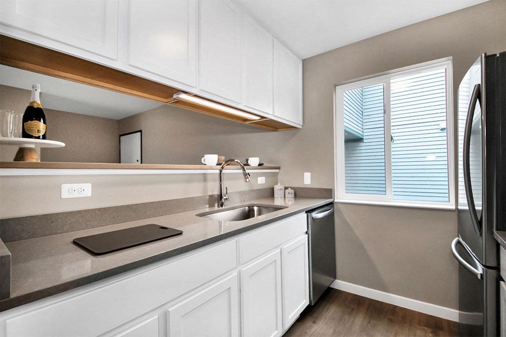 a kitchen with a sink and a refrigerator