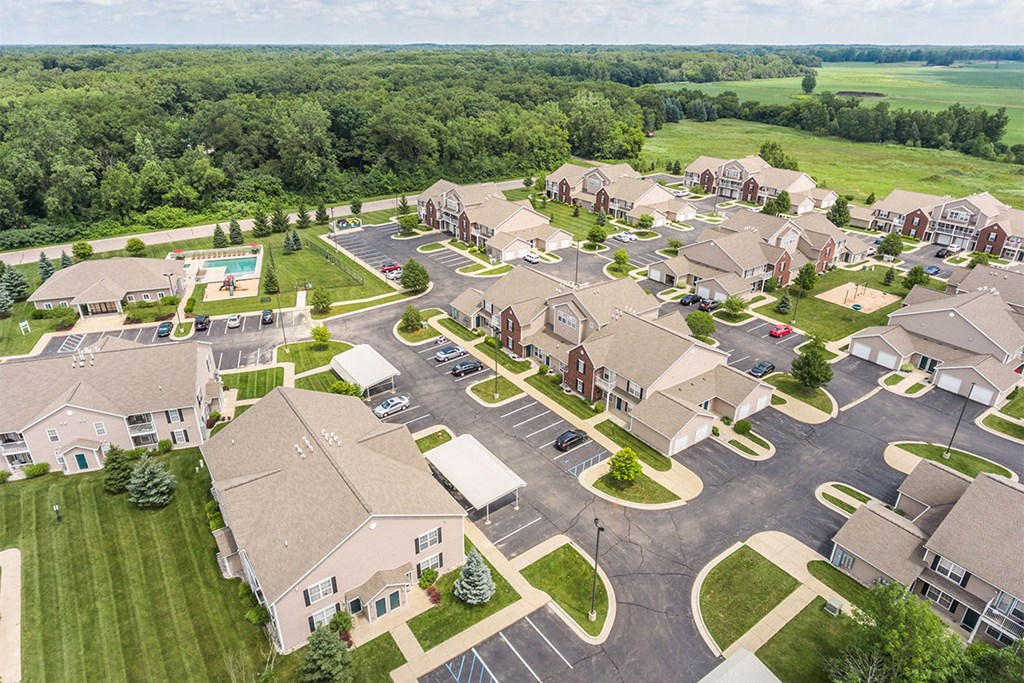 an aerial view of a large neighborhood with houses and a parking lot