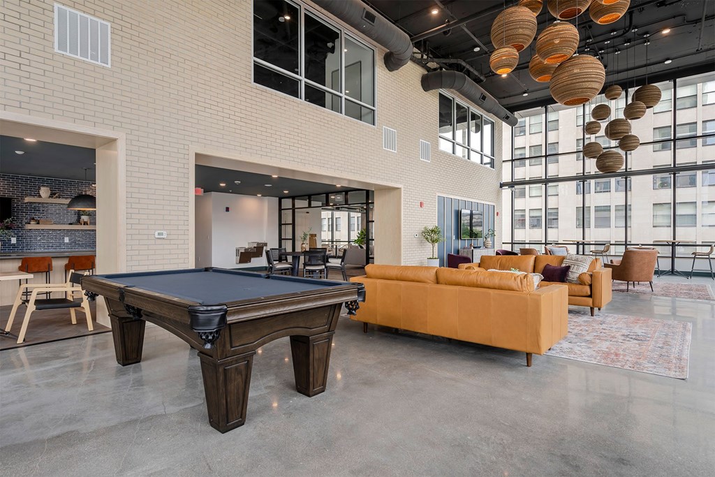 apartment lobby with a pool table and sofas