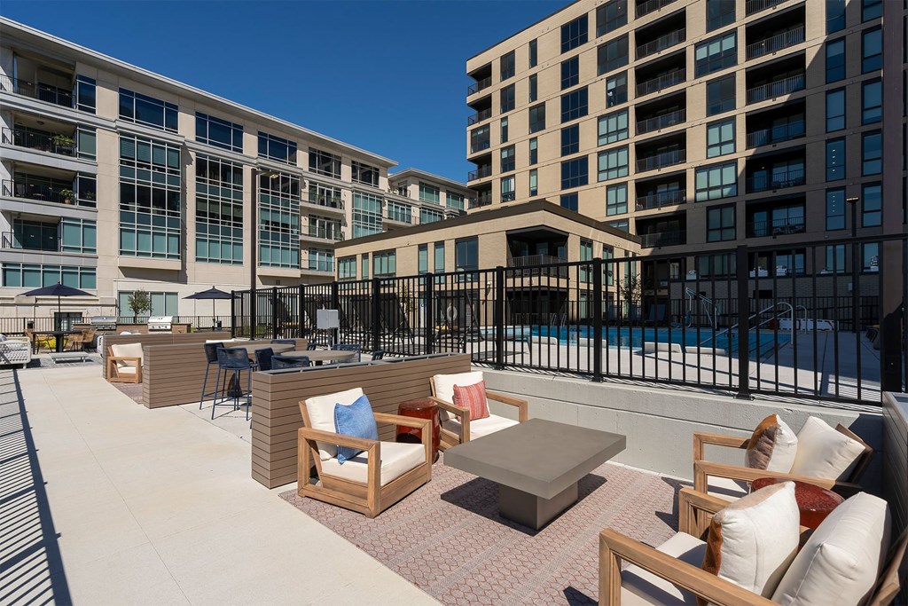 outdoor rooftop lounge with chairs near the pool