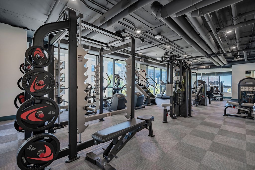 fitness center with weight equipment and large windows