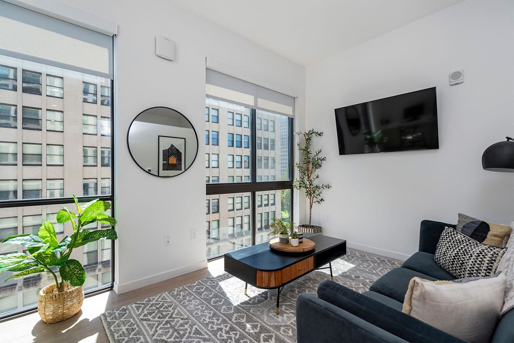 a living room with a large window and a couch
