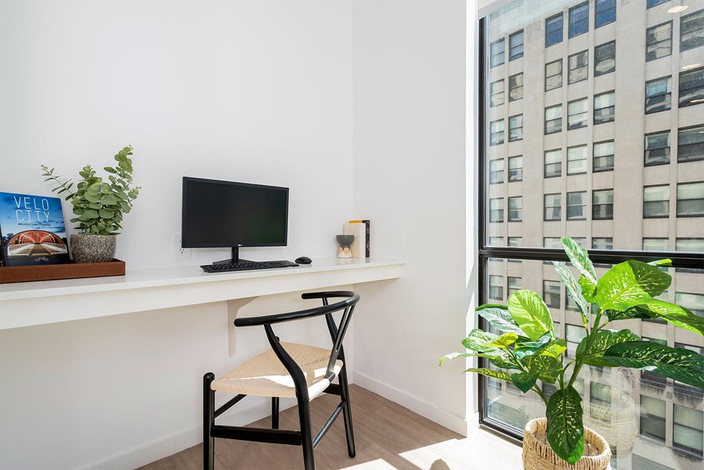 apartment office nook with computer and large high rise window