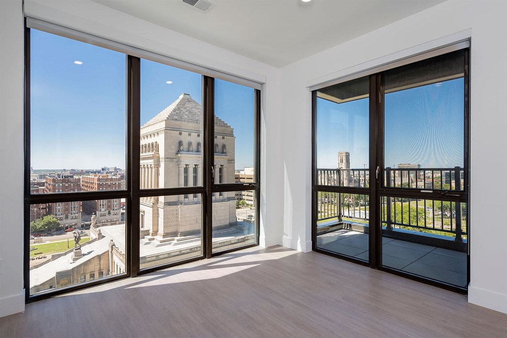 apartment living room with balcony door and large windows