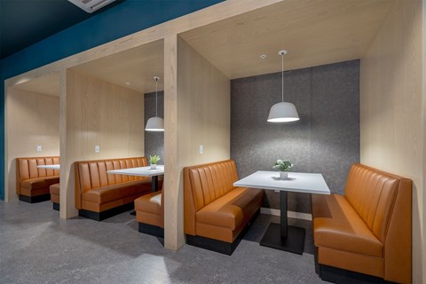 a dining room with orange chairs and a white table