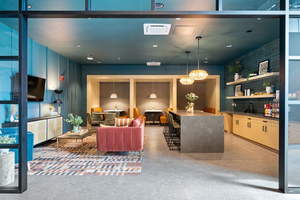 a living room with blue walls and a kitchen