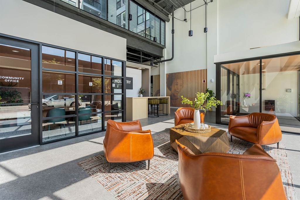 a lobby with leather chairs and a table