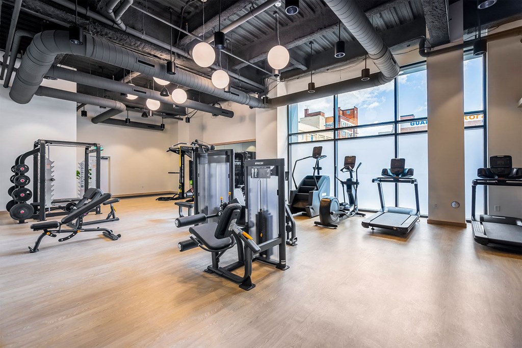 a gym with weights and other exercise equipment in a building