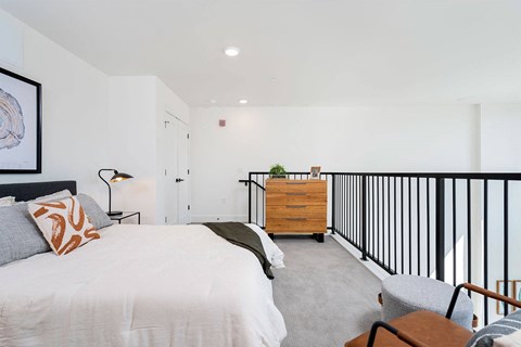 a bedroom with a bed and a railing