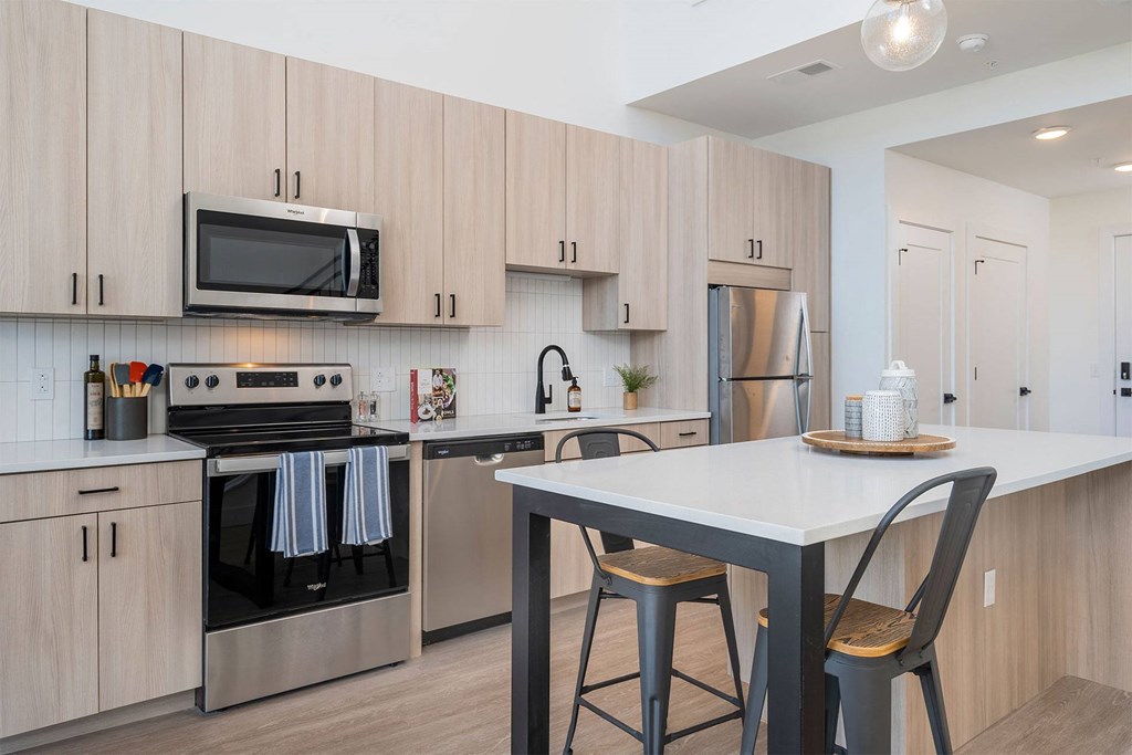 a kitchen with wooden cabinets and stainless steel appliances