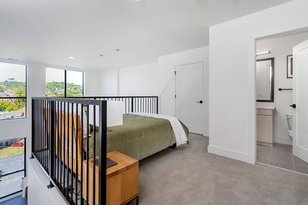 a bedroom with a bed and a balcony