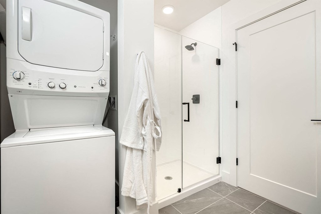 a white washer and dryer in a small laundry room