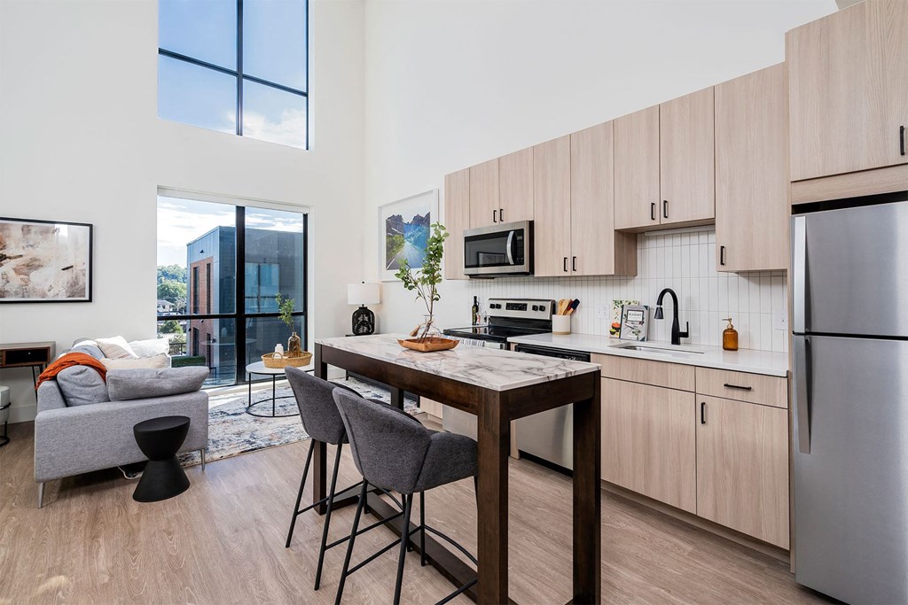 a kitchen with an island and a table with chairs