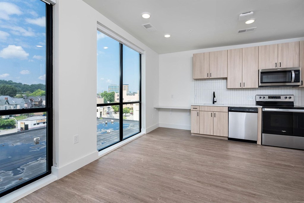 a kitchen with a large window and a stove and a sink