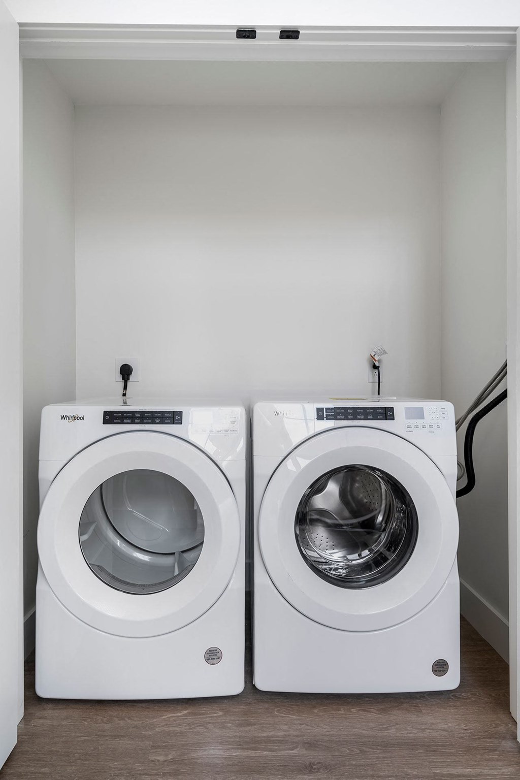 a washer and dryer in a laundry room with white walls