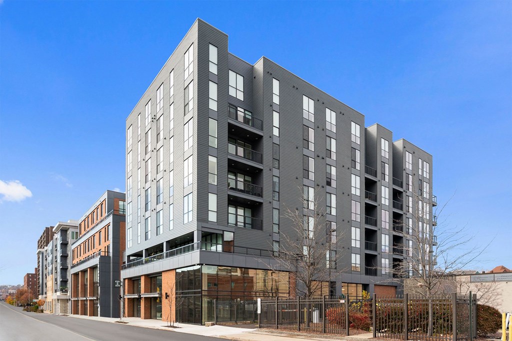 new apartment building on the corner of a city street