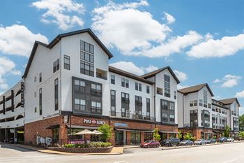 a rendering of a new apartment building on a city street