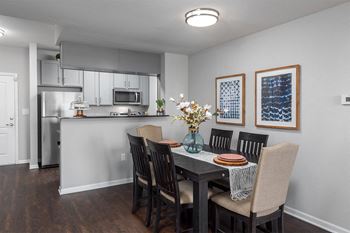 a dining room with a table and chairs and a kitchen