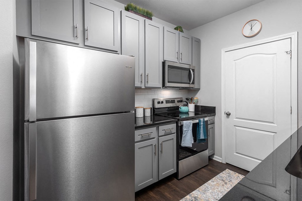 a kitchen with stainless steel appliances and white cabinets