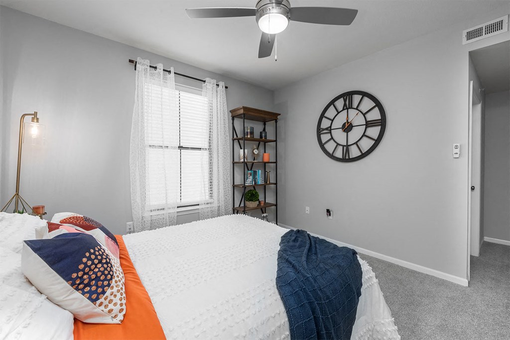 bedroom with a large bed and a clock on the wall