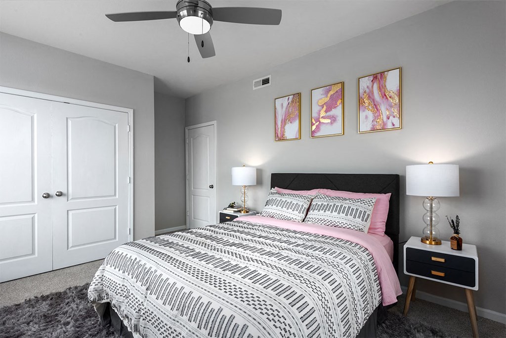 a bedroom with a bed and a ceiling fan