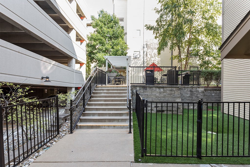 the stairway down to the backyard of a building with stairs and a fence