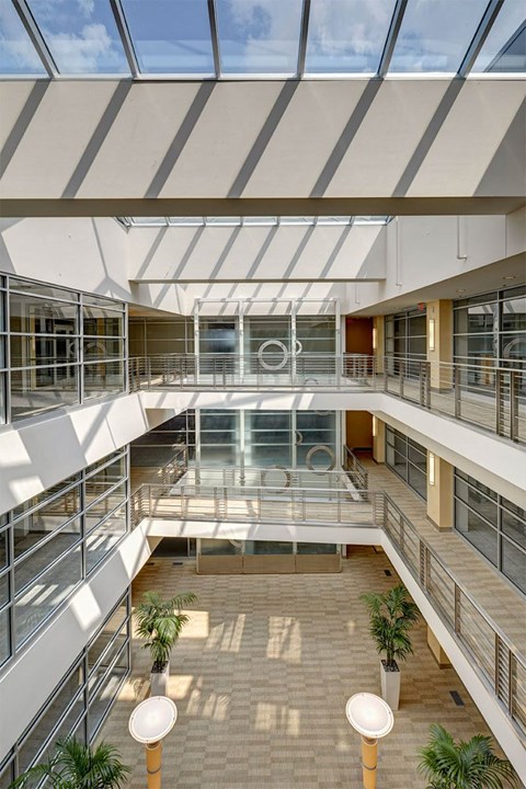 A modern atrium with a glass ceiling and a skylight.