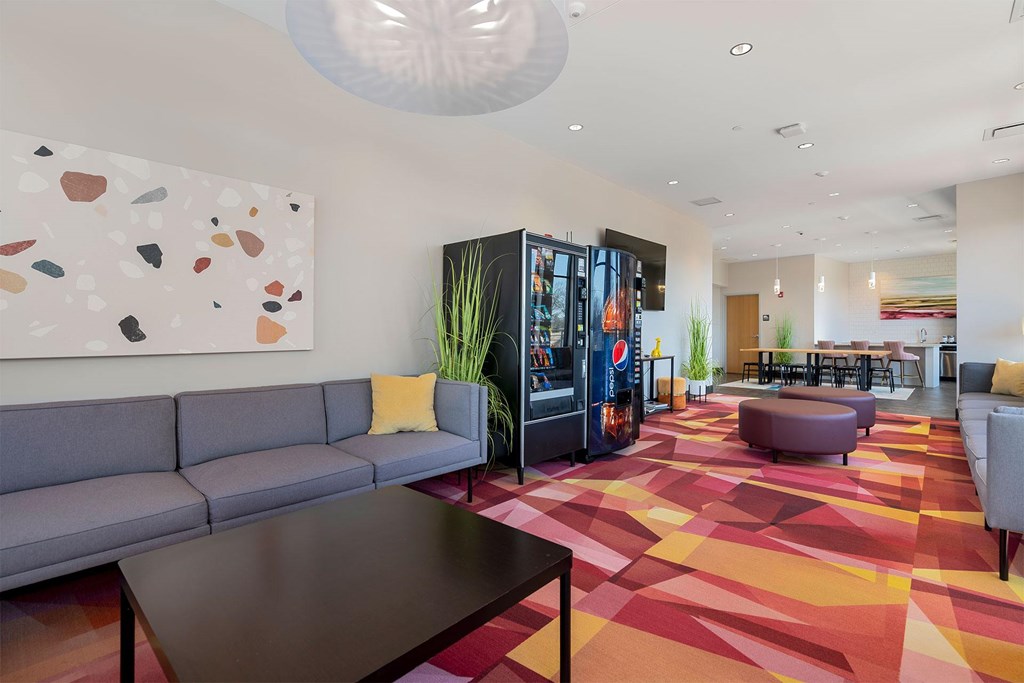 A modern living room with a grey sofa and a wooden coffee table.