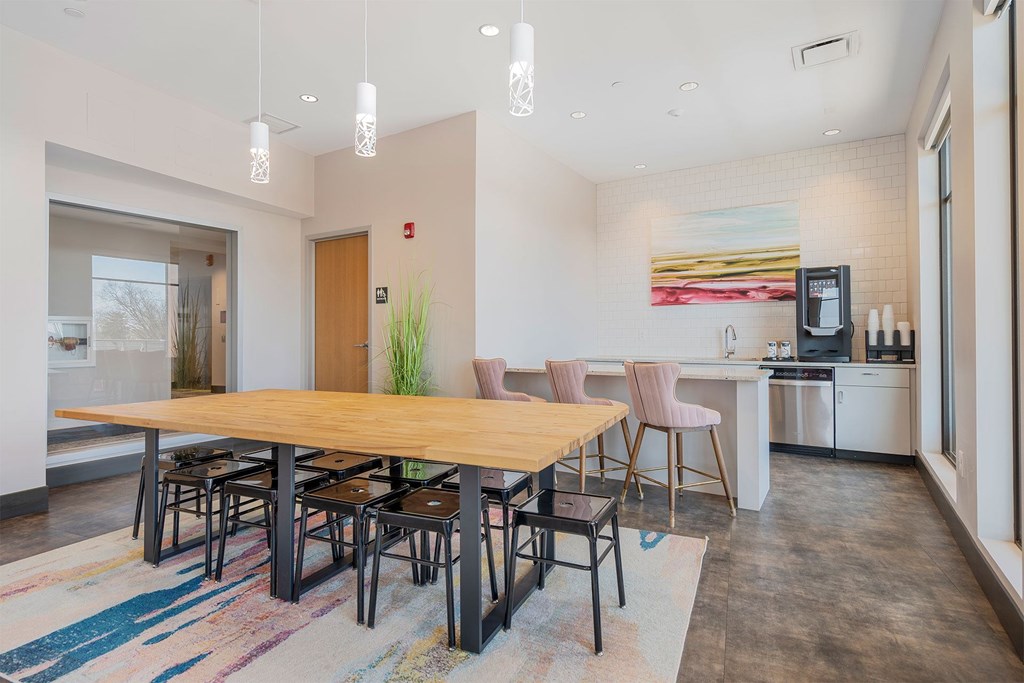A modern dining room with a wooden table and chairs.
