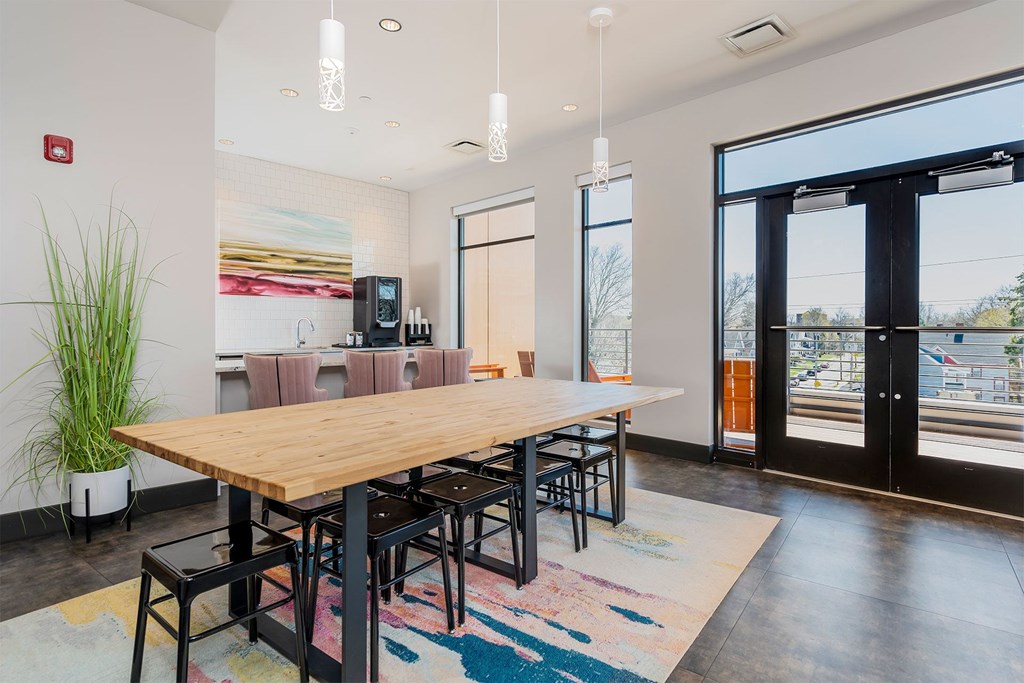 A modern dining room with a wooden table and chairs.