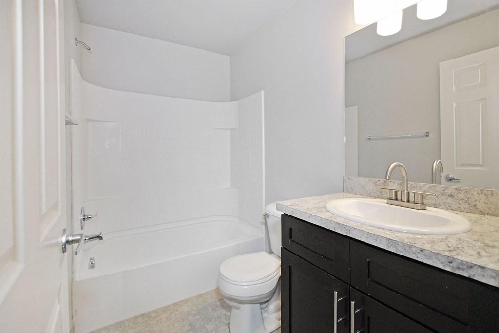 a bathroom with a sink and a toilet and a shower