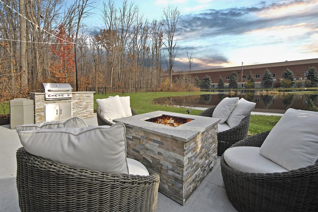 a patio with furniture and a fire pit