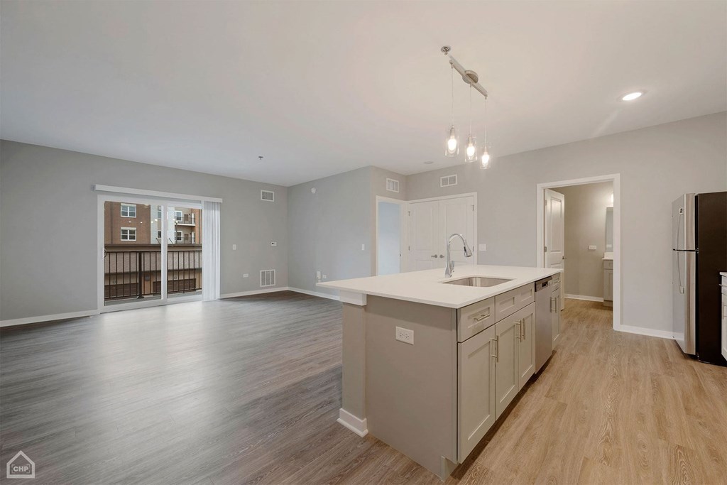 an empty kitchen and living room with an open floor plan