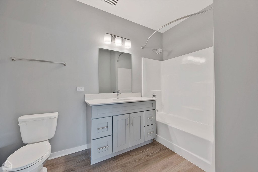 a bathroom with a toilet sink and a mirror