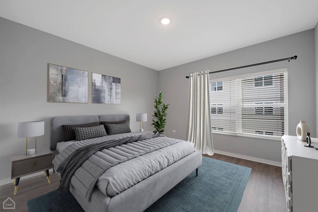 a bedroom with a bed and a large window