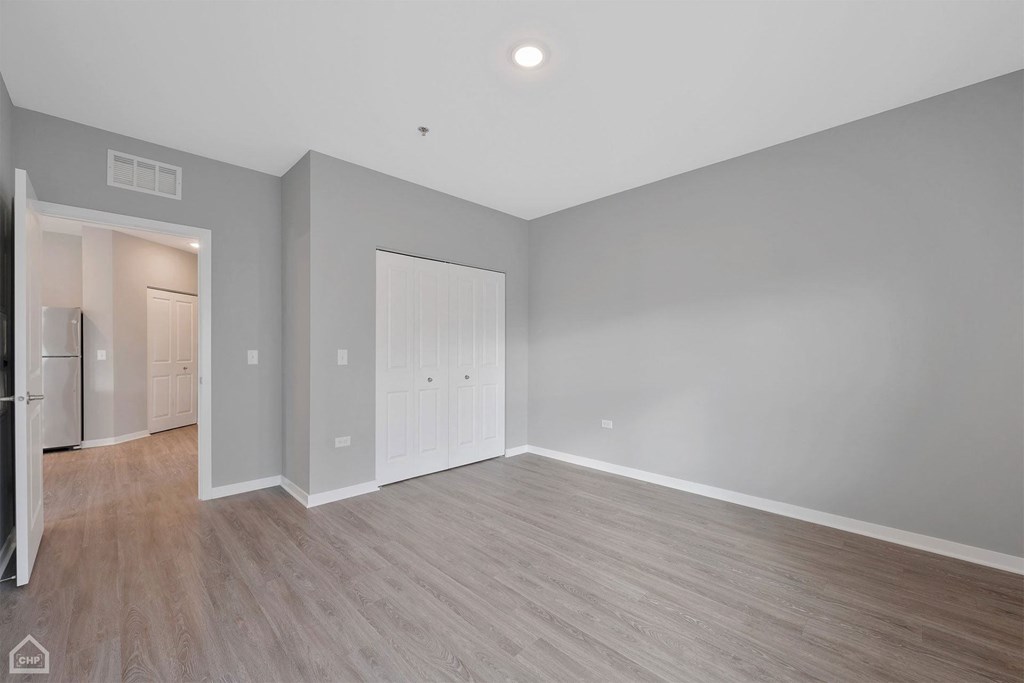 a living room with grey walls and wood floors