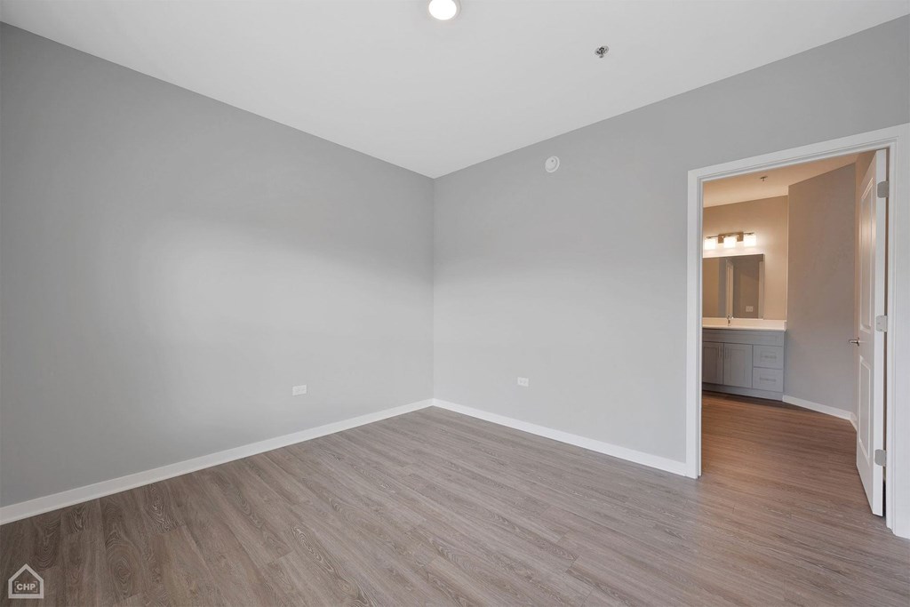 a living room with white walls and wood floors