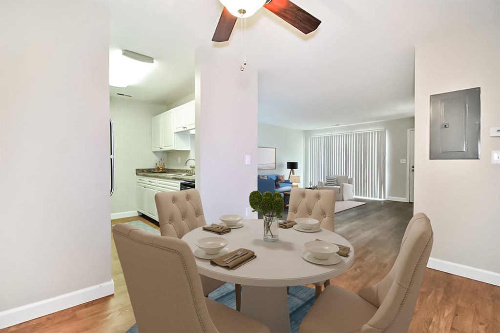 A dining room with a table set for four.