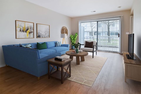 A blue couch sits in a living room with a wooden coffee table in front of it.