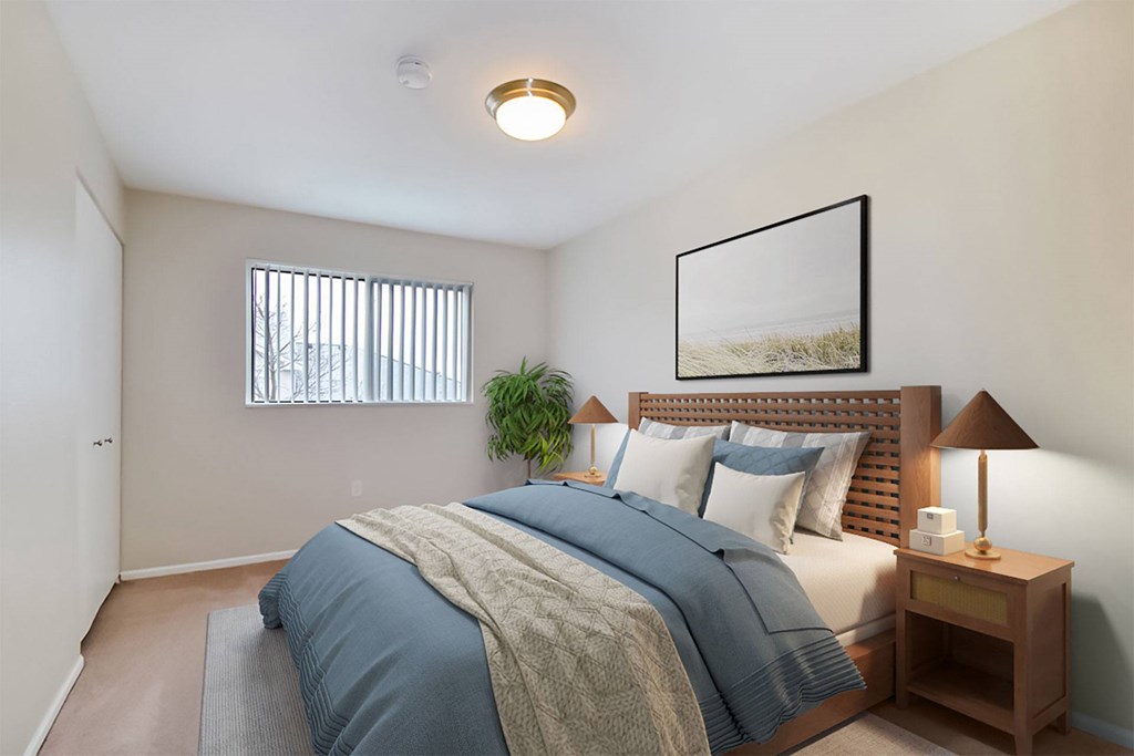 A bedroom with a bed, nightstand, and lamp.